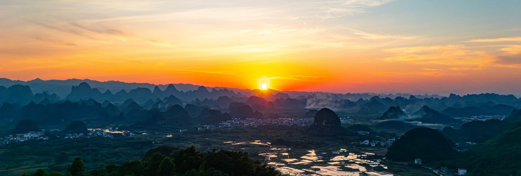 Sunset over karst hills and water
