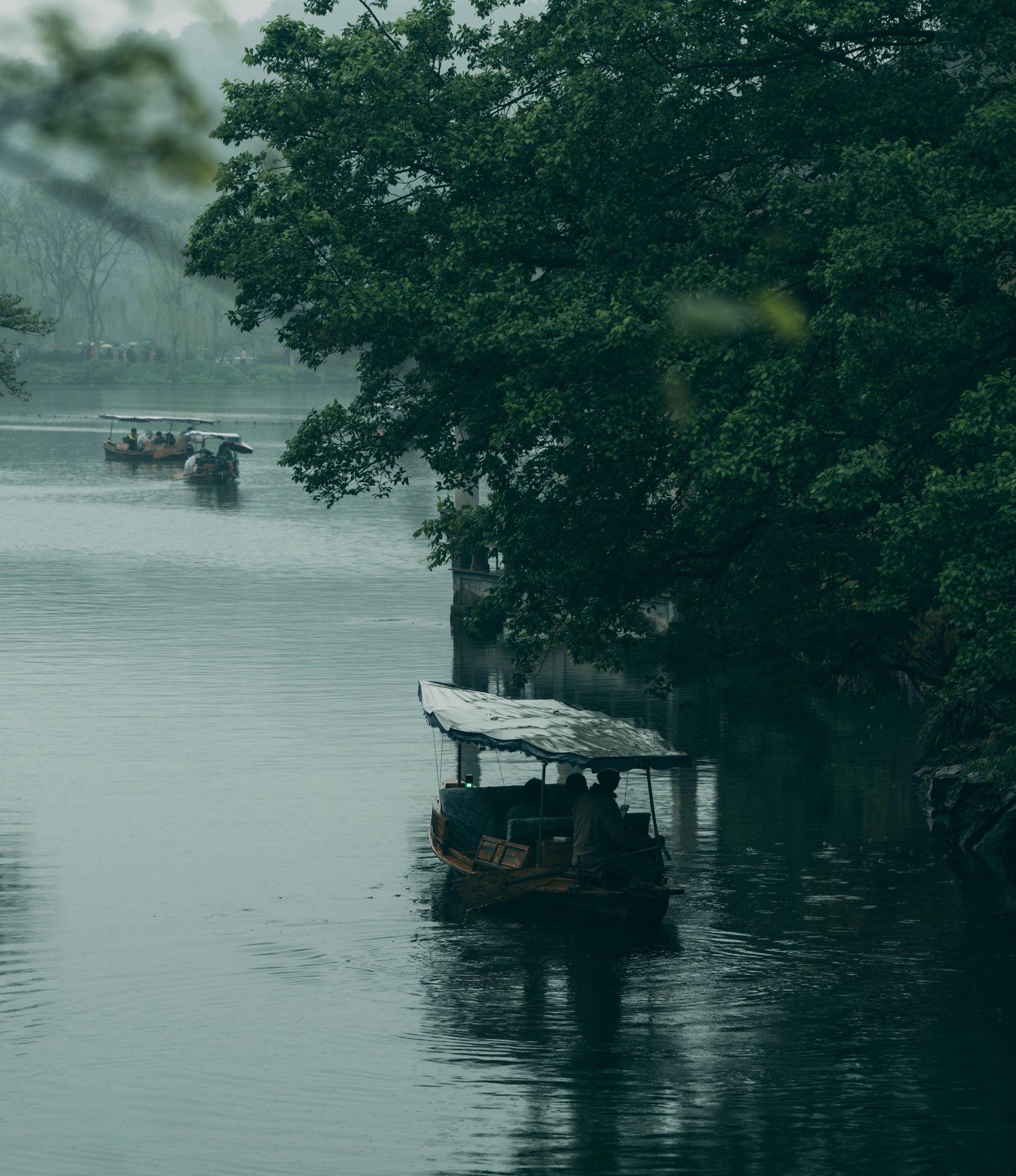 Boats crossing a misty lake