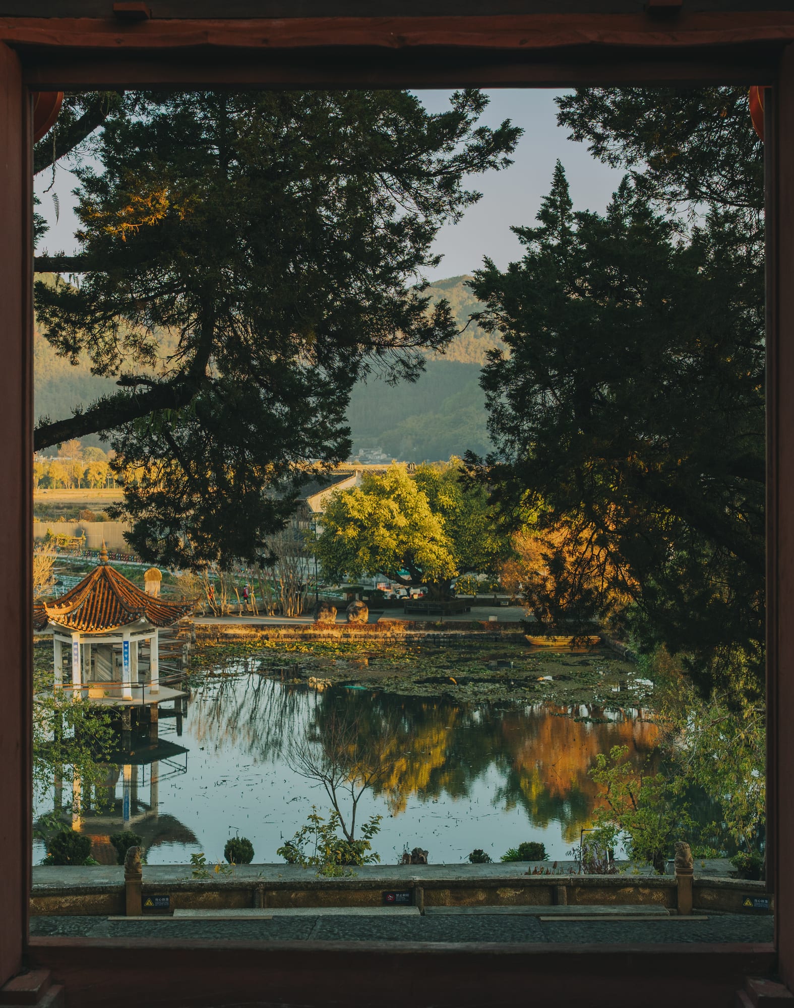 A garden pavilion reflected in a lake