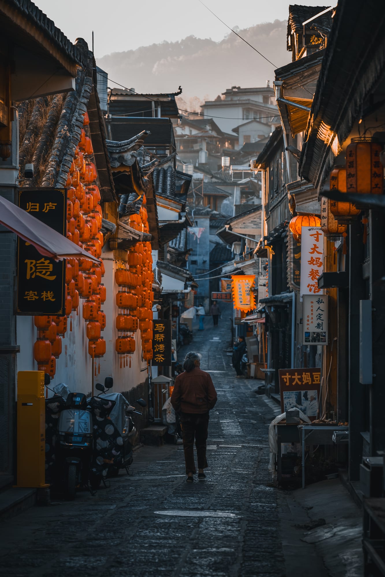 Lanterns lining an old town street at dusk