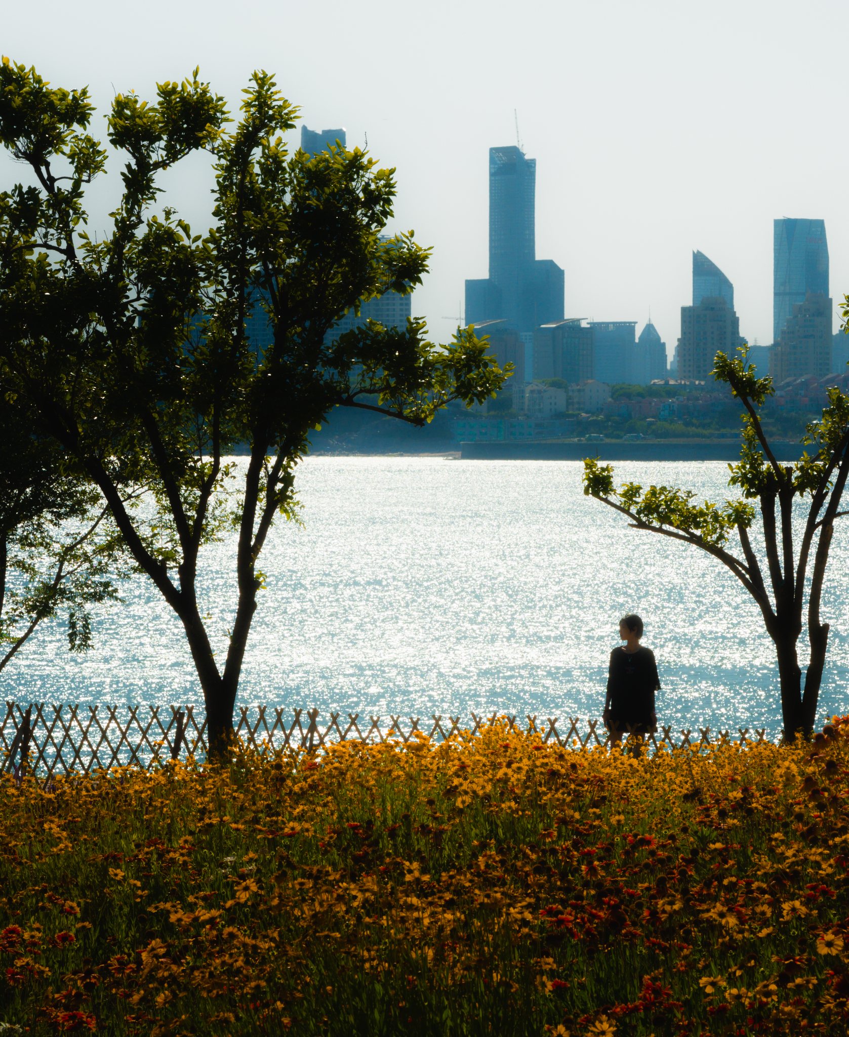 A woman by the shore among wildflowers