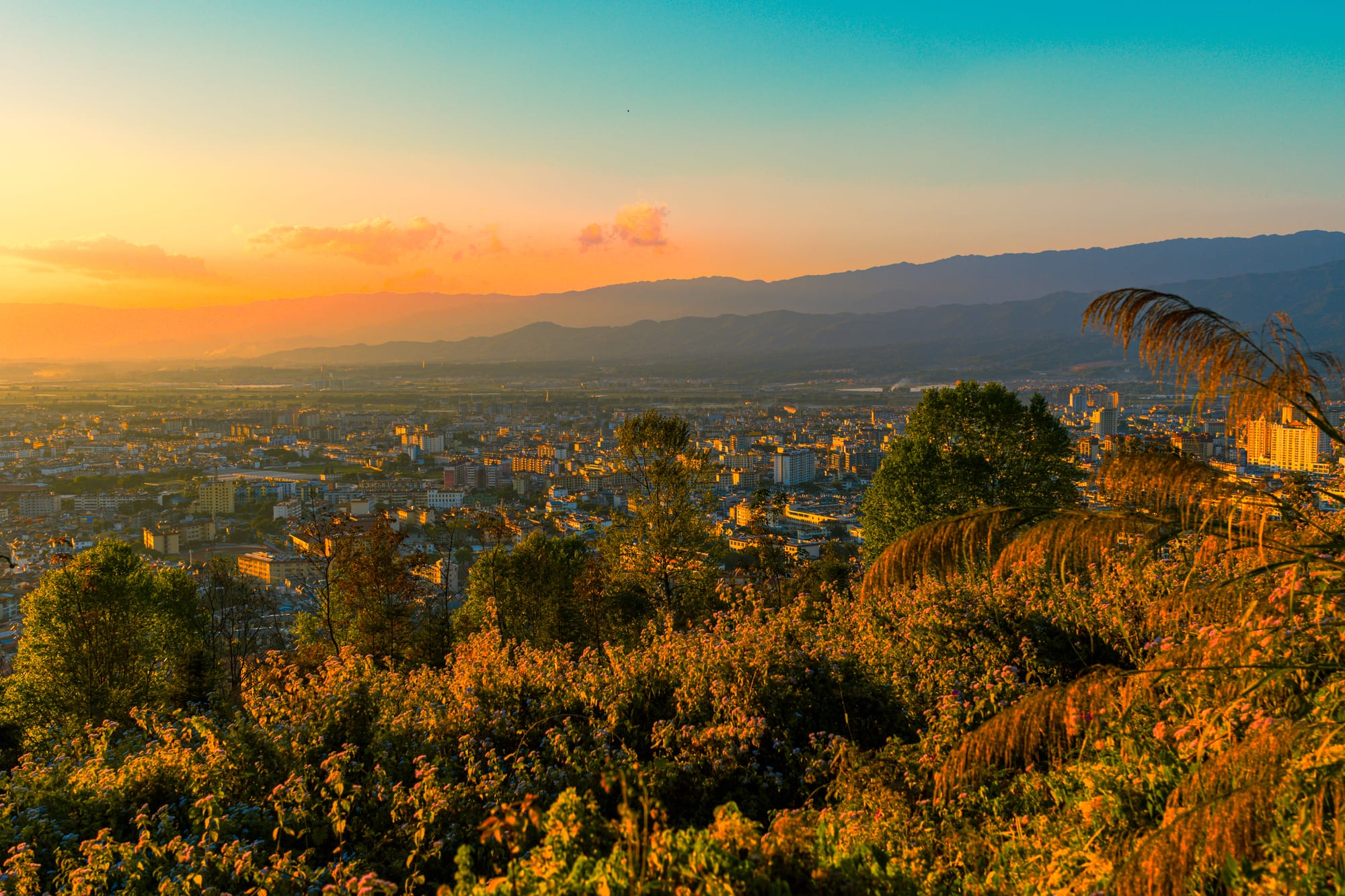 A valley town at sunset from a hillside