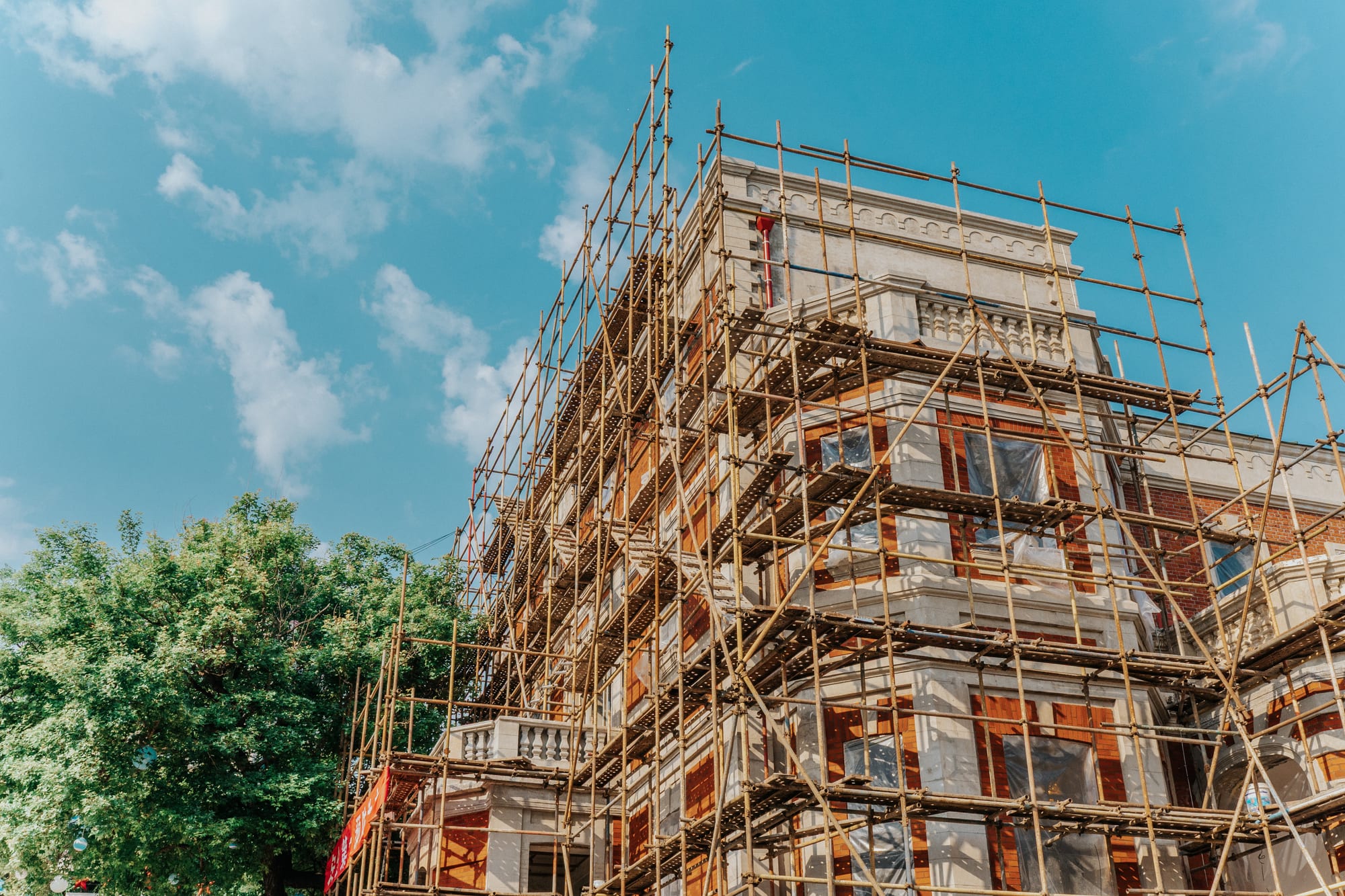 A building wrapped in scaffold against the sky