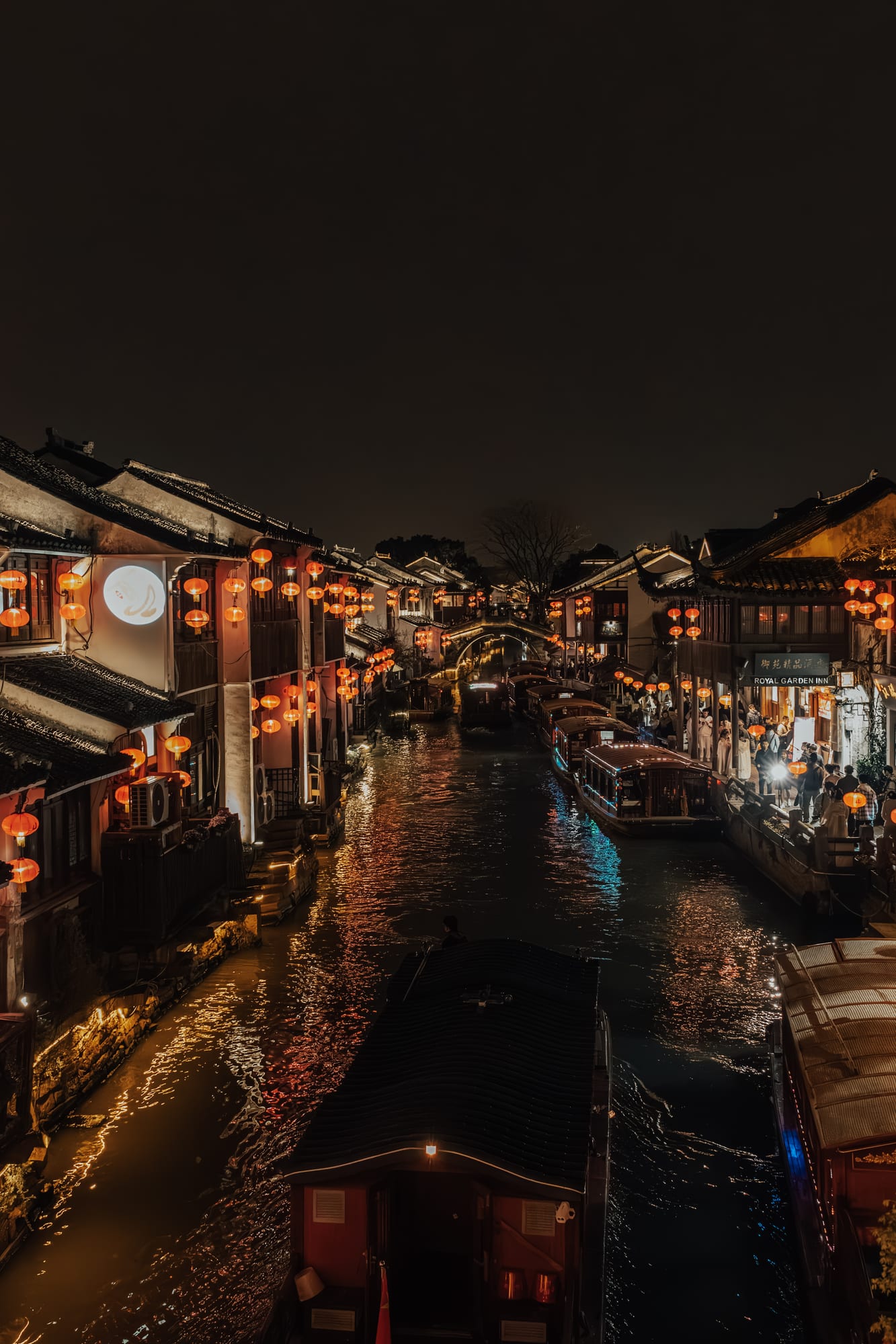 Red lanterns over a night canal town