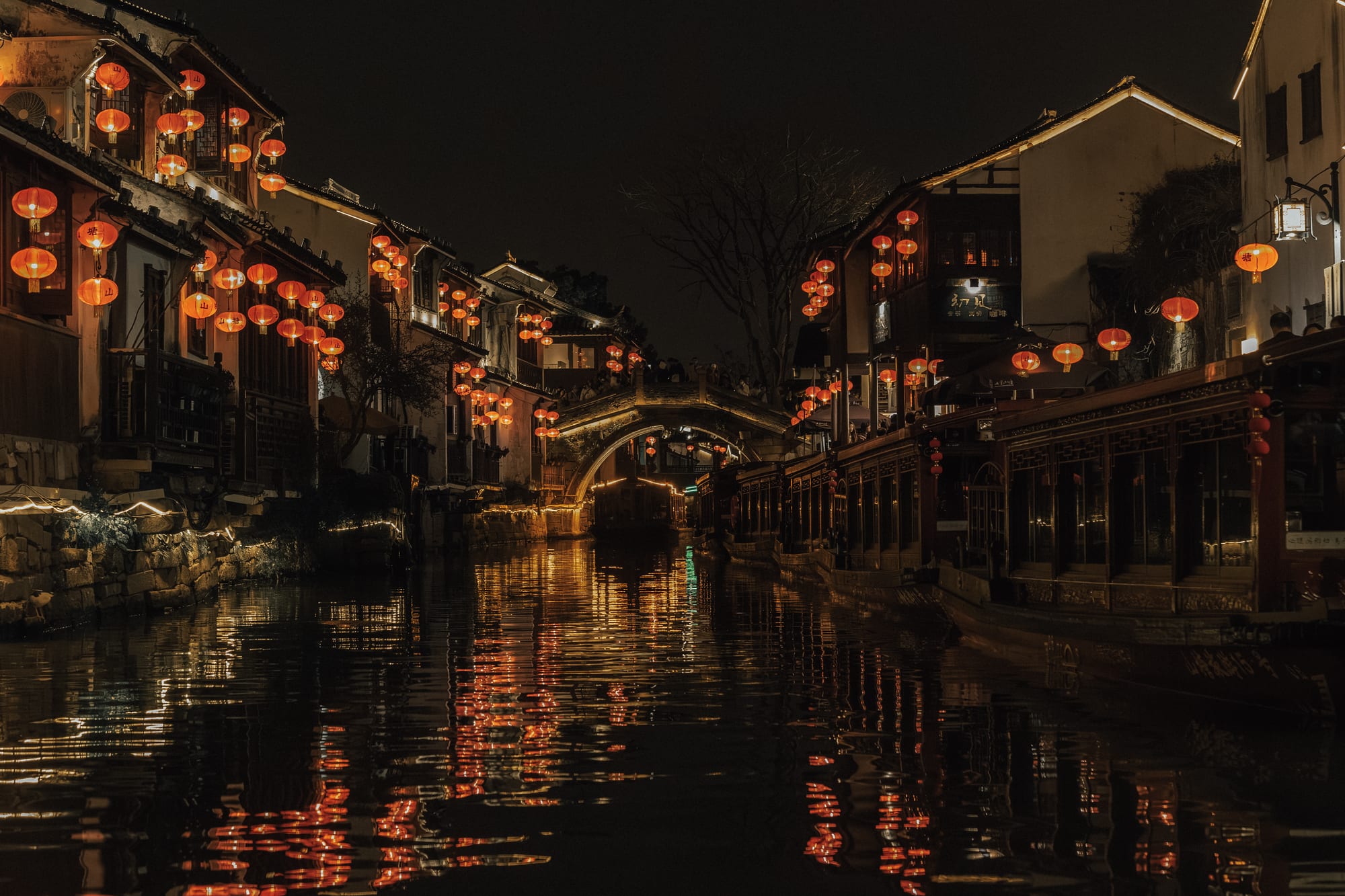 Lanterns reflecting on a night canal