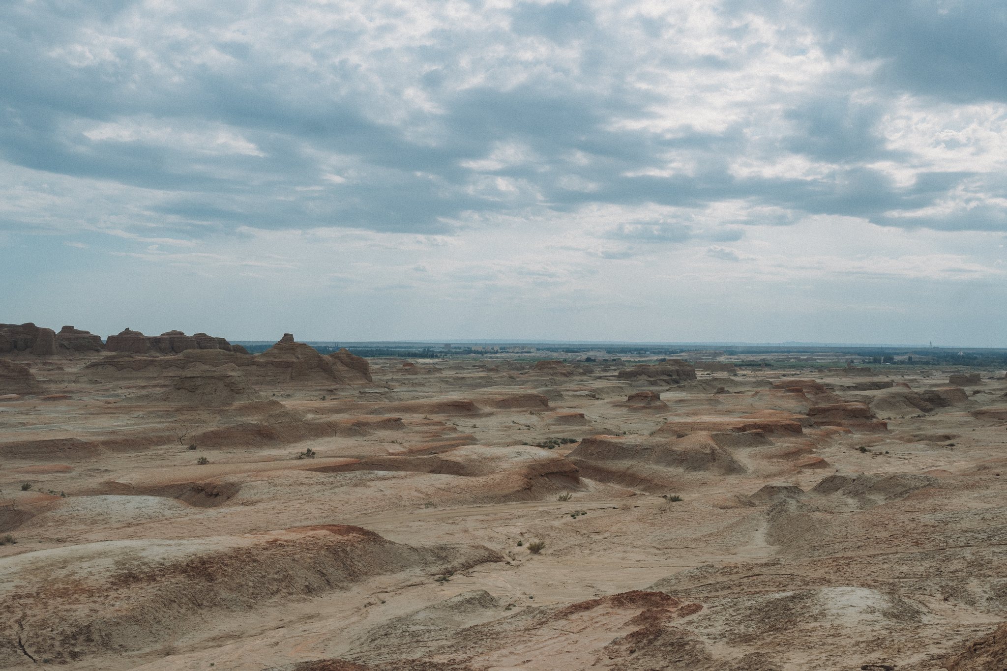 Eroded desert badlands under a wide sky